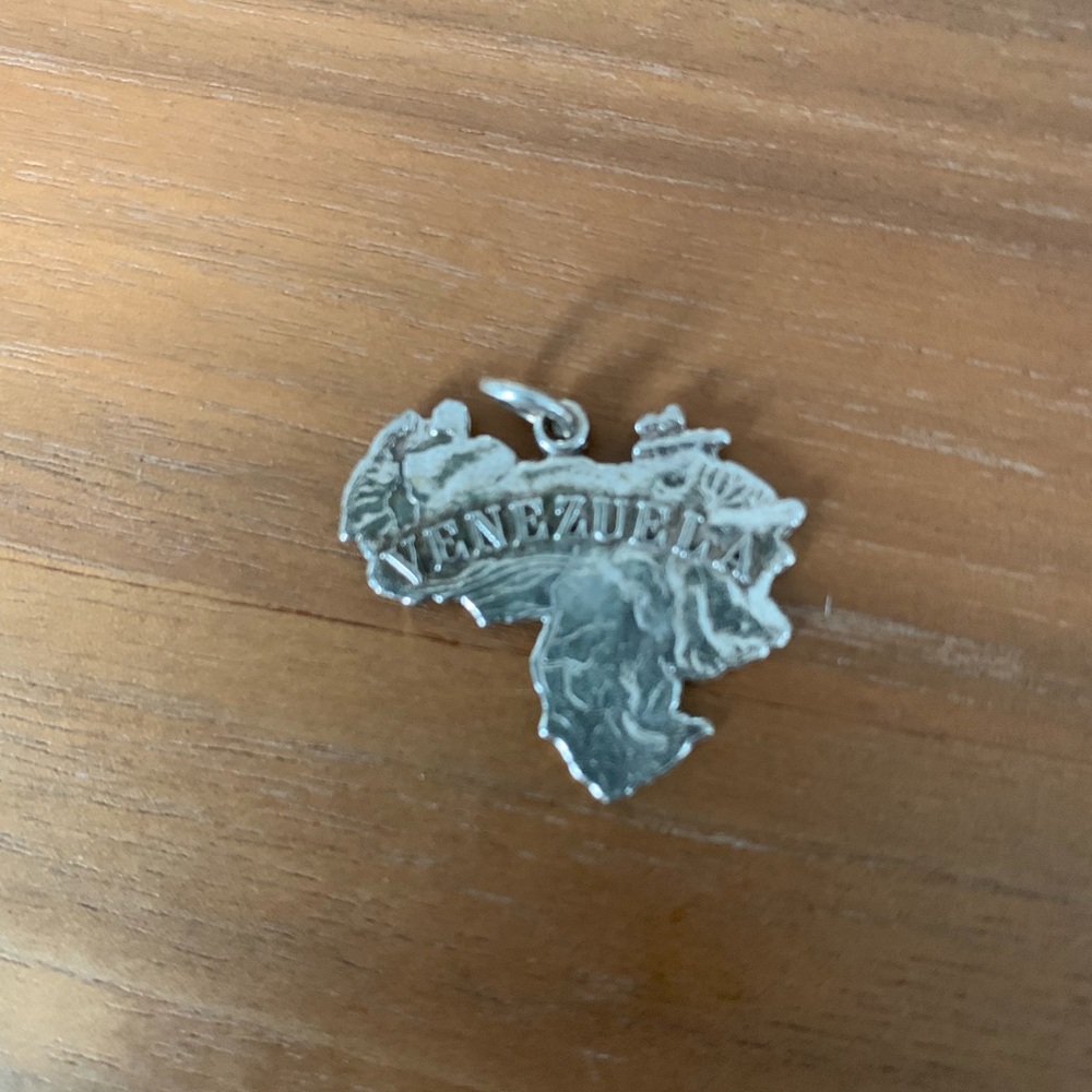 1” silver Venezuela map pendant.
